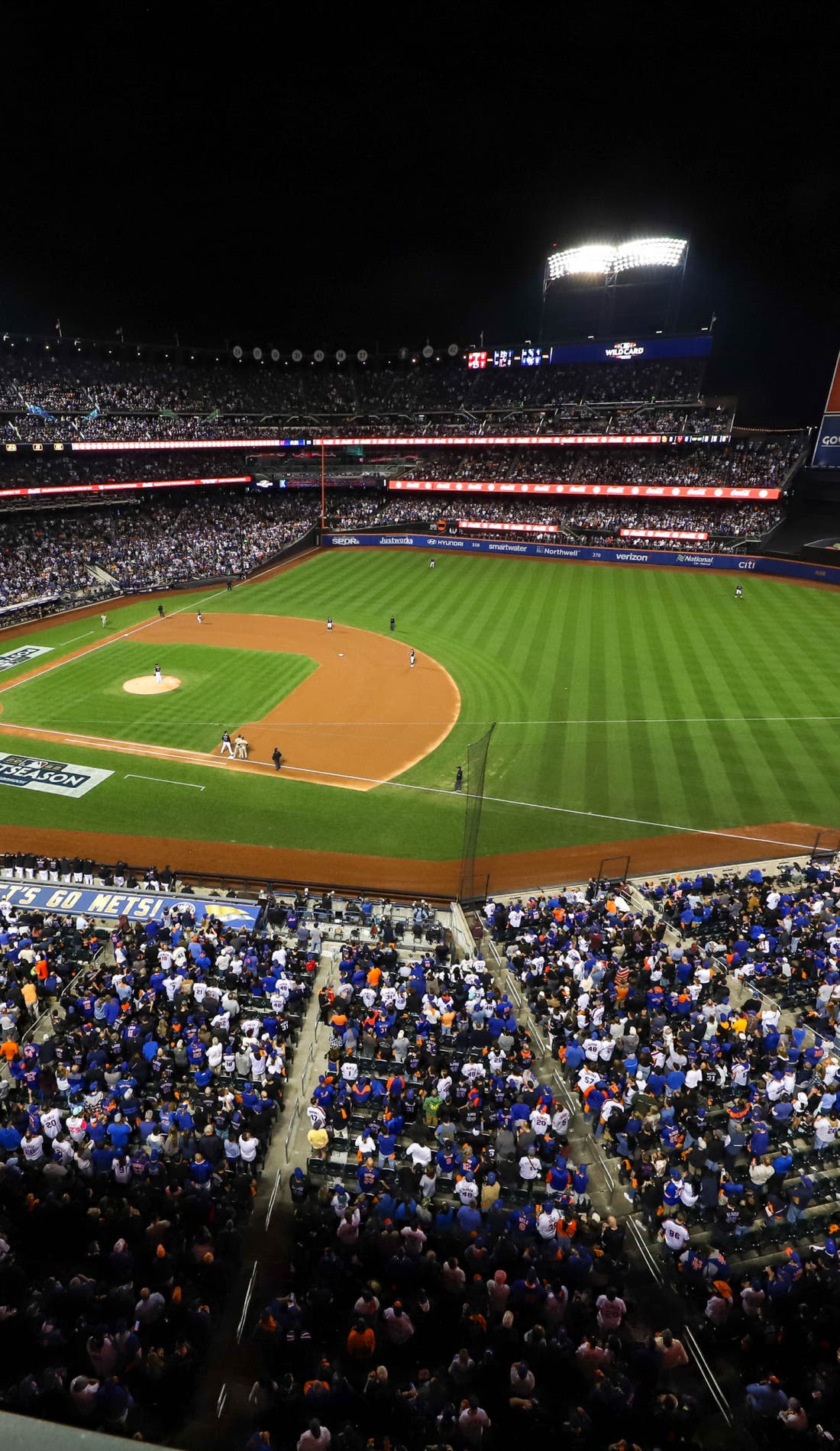 View from a seat at a New York Mets vs Texas Rangers game, showing the teams playing
