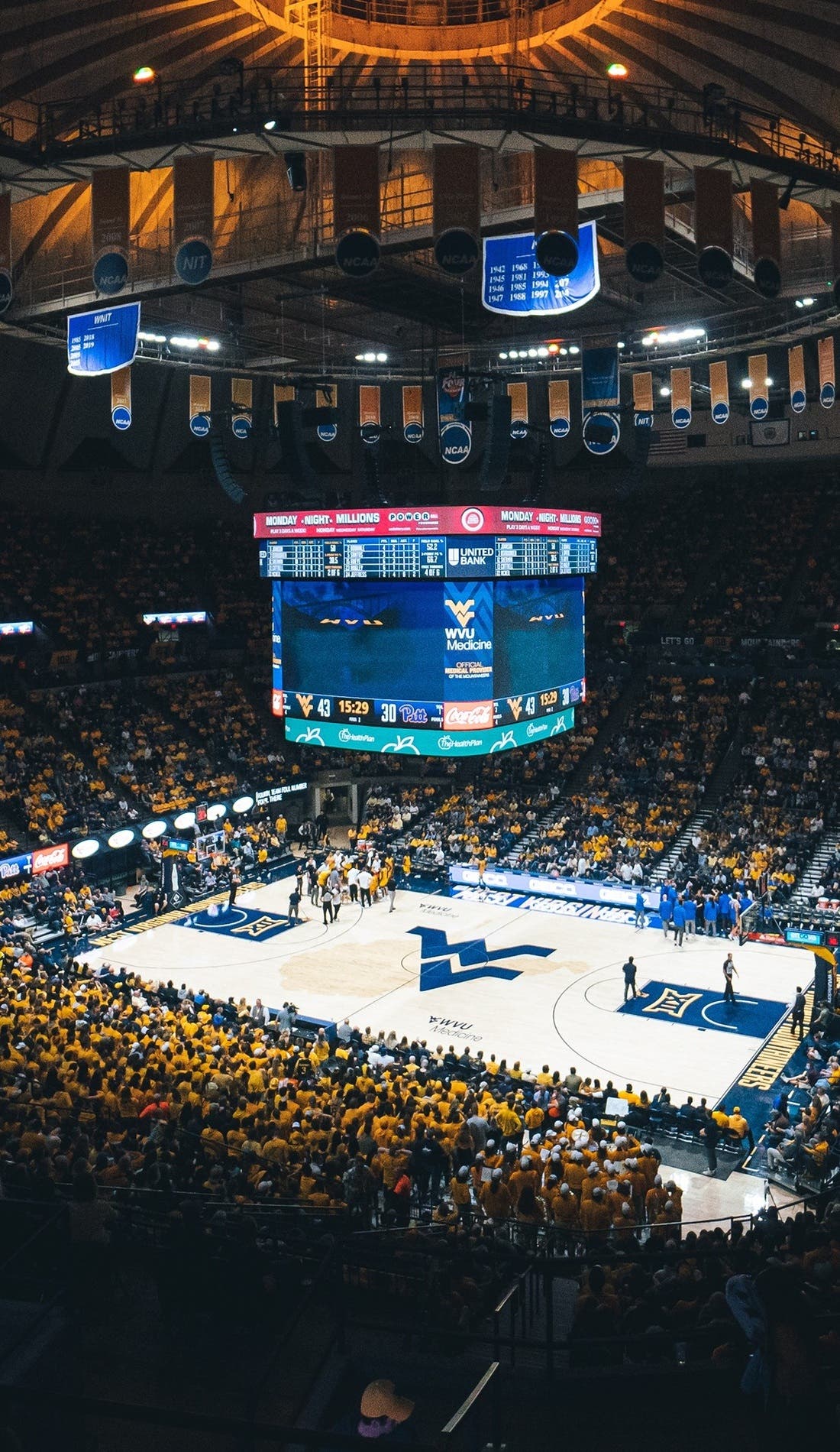 View from a seat at a West Virginia Mountaineers Mens Basketball vs Lehigh Mountain Hawks Mens Basketball game, showing the teams playing